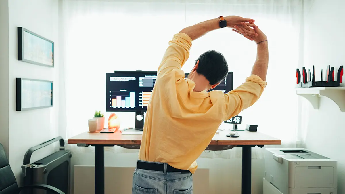Office worker performing a stretching exercise at their desk